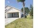 Garage space featuring a utility sink, laundry, and open garage door at 323 Miami Ln, Kissimmee, FL 34759