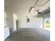Spacious garage with water heater and concrete flooring at 323 Miami Ln, Kissimmee, FL 34759