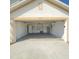 View of house 323 garage with new concrete flooring at 323 Miami Ln, Kissimmee, FL 34759