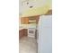 Kitchen features white appliances, tile floors, and wooden cabinetry at 323 Miami Ln, Kissimmee, FL 34759