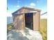 Exterior view of the storage shed with an open door at 323 Miami Ln, Kissimmee, FL 34759
