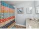 Bright bathroom featuring a colorful shower curtain and a turtle-themed decoration at 5003 Timber Ridge Trl, Ocoee, FL 34761