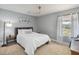 Neutral bedroom with a bed, side table, and a window for natural light at 5003 Timber Ridge Trl, Ocoee, FL 34761