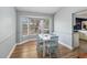 Dining room with a bay window, a white table, and four cushioned chairs at 5003 Timber Ridge Trl, Ocoee, FL 34761