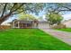 A beautiful front lawn and driveway leading to a house creates a welcoming entrance at 5003 Timber Ridge Trl, Ocoee, FL 34761