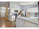Open kitchen features white cabinets, tile floors, and ample counter space for meal preparation at 5003 Timber Ridge Trl, Ocoee, FL 34761
