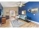 Inviting living room with blue accent wall, ceiling fan, and wood flooring at 5003 Timber Ridge Trl, Ocoee, FL 34761