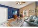 Bright living room with a ceiling fan, TV, and natural light from the window at 5003 Timber Ridge Trl, Ocoee, FL 34761