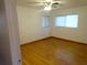 Cozy bedroom featuring hardwood floors and a ceiling fan at 902 S Scenic Hwy, Lake Wales, FL 33853