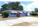 Single-story home with concrete driveway and awning covered windows at 902 S Scenic Hwy, Lake Wales, FL 33853
