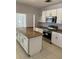 Renovated kitchen with stainless steel appliances and an island at 902 S Scenic Hwy, Lake Wales, FL 33853