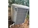 Exterior image of a gray air conditioning unit with vegetation around at 246 Ridge Manor Dr, Lake Wales, FL 33853