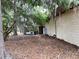 Backyard view highlighting mature trees, outdoor storage and unique design of the exterior at 246 Ridge Manor Dr, Lake Wales, FL 33853