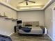 Bedroom with gray walls, tray ceiling, and shelves above bed at 246 Ridge Manor Dr, Lake Wales, FL 33853