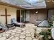 Charming courtyard with unique flooring, lush greenery, seating, and tranquil ambiance at 246 Ridge Manor Dr, Lake Wales, FL 33853