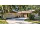 Charming single-story home with a long driveway and mature landscaping at 246 Ridge Manor Dr, Lake Wales, FL 33853