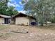 Exterior view of the home showcasing its unique design and backyard setting at 246 Ridge Manor Dr, Lake Wales, FL 33853
