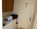 Laundry room with washer and dryer, overhead cabinets and utility sink at 246 Ridge Manor Dr, Lake Wales, FL 33853