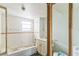View of the bathroom with white tile, a bathtub and shower combo, sink and toilet at 515 New York Ave, St Cloud, FL 34769