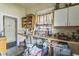 Functional kitchen features an open shelving unit and double sink under a bright window at 515 New York Ave, St Cloud, FL 34769