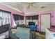 View of the living room with dark curtains, dated decor, and a ceiling fan at 515 New York Ave, St Cloud, FL 34769