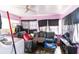 Cozy living room with a ceiling fan, plush gray couch, and natural light from the windows at 515 New York Ave, St Cloud, FL 34769