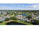 Aerial view showcasing homes surrounded by ponds and green spaces in a residential neighborhood at 13532 Meadow Bay Loop, Orlando, FL 32824