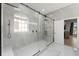 Modern bathroom featuring a large, glass-enclosed shower with a rainfall showerhead and window at 13532 Meadow Bay Loop, Orlando, FL 32824