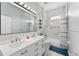 Stylish bathroom features a double vanity, modern lighting, and a shower-tub combination with sleek fixtures at 13532 Meadow Bay Loop, Orlando, FL 32824