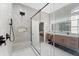 A spacious bathroom with a frameless shower, modern vanity and lighting, and an open doorway at 13532 Meadow Bay Loop, Orlando, FL 32824