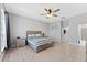 Bright bedroom featuring neutral tones, a ceiling fan, and a comfortable bed with a wooden frame at 13532 Meadow Bay Loop, Orlando, FL 32824