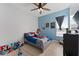 Fun, colorful bedroom with blue accents, a ceiling fan, and a single bed with playful decor at 13532 Meadow Bay Loop, Orlando, FL 32824
