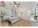 Charming bedroom with colorful decorations, a ceiling fan, and a cozy bed with a rainbow theme at 13532 Meadow Bay Loop, Orlando, FL 32824