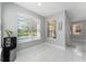 Bright breakfast nook has white marble floors, large windows, and outside views at 13532 Meadow Bay Loop, Orlando, FL 32824