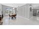 Bright dining area showcases modern lighting, white trim, large windows, and views into the Gathering room at 13532 Meadow Bay Loop, Orlando, FL 32824