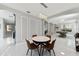Bright dining area showcases modern lighting, white trim, large windows, and views into the living room at 13532 Meadow Bay Loop, Orlando, FL 32824