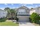 Charming two-story home featuring stone accents, a manicured lawn, and a two-car garage at 13532 Meadow Bay Loop, Orlando, FL 32824