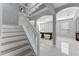 Bright foyer features staircase, soaring ceilings, and archways leading to the living areas, creating an open and inviting entrance at 13532 Meadow Bay Loop, Orlando, FL 32824
