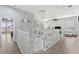 Open-concept interior view featuring a staircase, chandelier, and a bright living area with comfortable seating at 13532 Meadow Bay Loop, Orlando, FL 32824