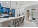 Modern kitchen featuring blue cabinets, a large island with seating, and stainless steel appliances at 13532 Meadow Bay Loop, Orlando, FL 32824