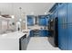 Stylish kitchen with blue cabinetry, stainless steel appliances, and ample counter space for cooking at 13532 Meadow Bay Loop, Orlando, FL 32824