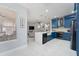 Well-lit kitchen area featuring blue cabinets, stainless steel appliances, and an open-concept design at 13532 Meadow Bay Loop, Orlando, FL 32824