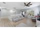 Bright living room with comfortable seating, a ceiling fan, and lots of natural light from a large window at 13532 Meadow Bay Loop, Orlando, FL 32824