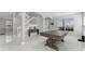 Open-concept living area with staircase, neutral walls, large windows, and marble flooring, perfect for entertaining at 13532 Meadow Bay Loop, Orlando, FL 32824