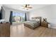 Spacious main bedroom features large windows, a ceiling fan, and a cozy bed with matching nightstands at 13532 Meadow Bay Loop, Orlando, FL 32824