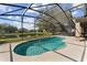 Screened in pool area features a pool and view of a pond at 13532 Meadow Bay Loop, Orlando, FL 32824
