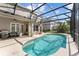 Screened in pool area features a pool, seating, a grill, and a fan at 13532 Meadow Bay Loop, Orlando, FL 32824