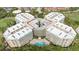 High angle shot of the condo complex, showcasing its unique layout, central parking, pool and surrounding landscape at 4 Oceans West Blvd # 502B, Daytona Beach, FL 32118