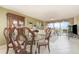 Elegant dining area offering an exquisite table set and a sunlit living space at 4 Oceans West Blvd # 502B, Daytona Beach, FL 32118