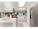 Modern kitchen featuring white cabinets, stainless steel appliances, and an adjacent dining area at 4 Oceans West Blvd # 502B, Daytona Beach, FL 32118